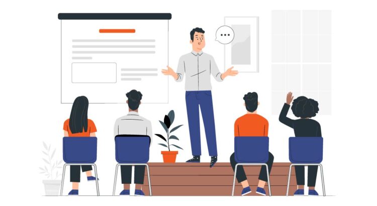 Illustration of a person teaching, with people seated in front of them, one with their hand up to ask a question. Behind the instructor is a screen with lines and a rectangle that suggests there is content for their class being displayed.
