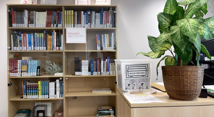 The TCDC library bookshelf with a plant in the foreground.